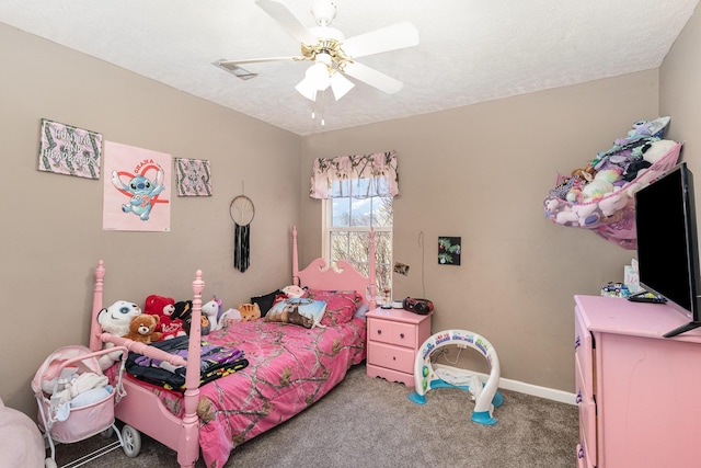 bedroom with ceiling fan, carpet floors, and a textured ceiling