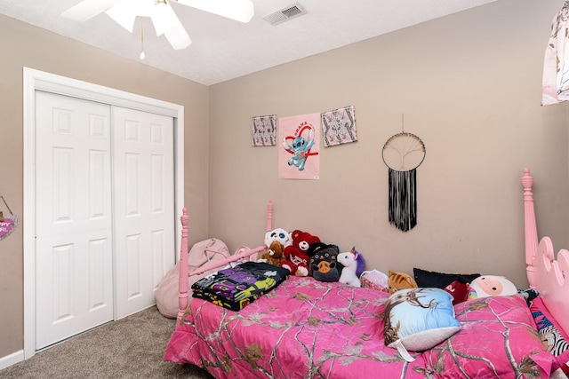 carpeted bedroom featuring a closet and ceiling fan