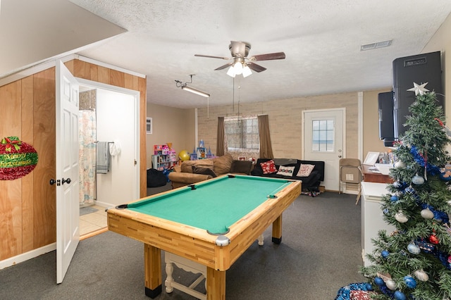 game room featuring billiards, ceiling fan, carpet floors, a textured ceiling, and wood walls