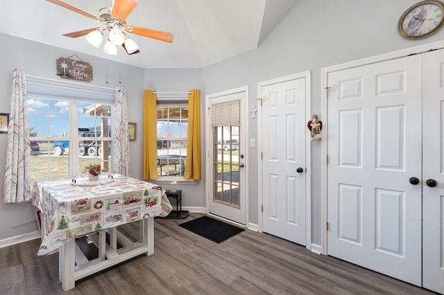 dining room featuring ceiling fan, lofted ceiling, and dark hardwood / wood-style flooring