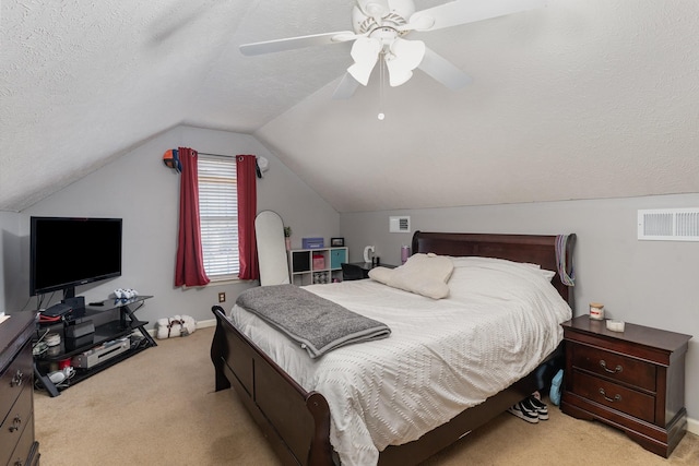 carpeted bedroom featuring ceiling fan, lofted ceiling, and a textured ceiling