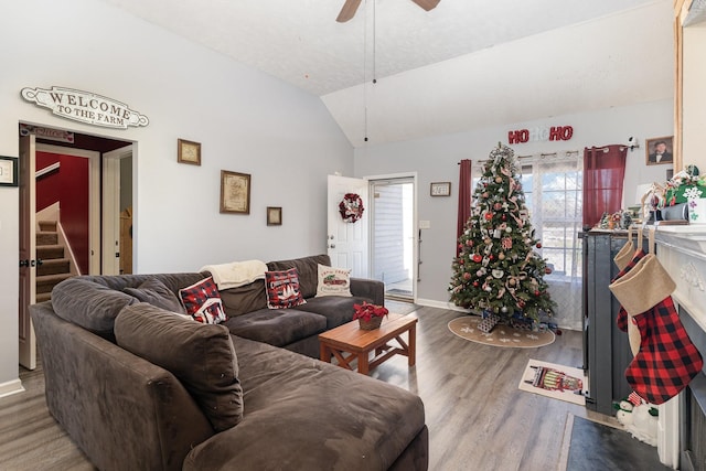 living room featuring wood-type flooring, vaulted ceiling, and ceiling fan