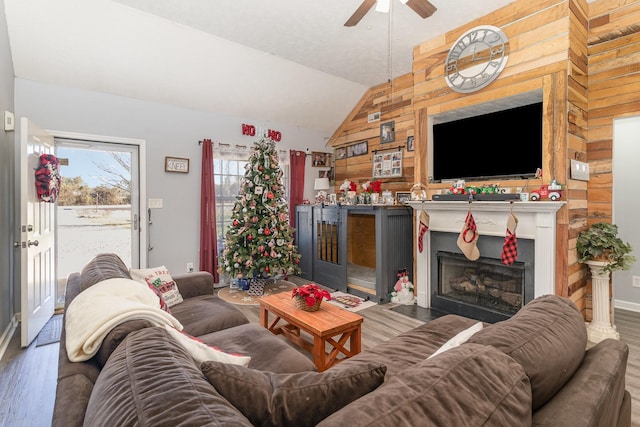 living room with wood-type flooring, lofted ceiling, and ceiling fan