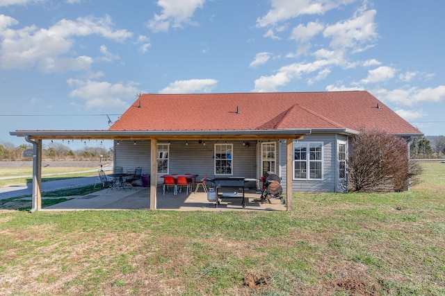 back of house featuring a yard and a patio area