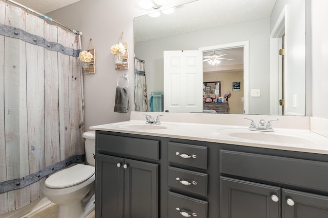 bathroom with vanity, ceiling fan, and toilet