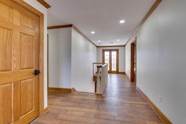 hall featuring wood-type flooring, crown molding, and french doors