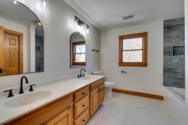 bathroom featuring vanity and toilet