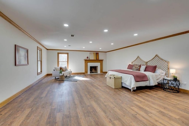 bedroom featuring ornamental molding and hardwood / wood-style floors