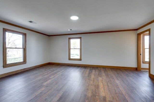 spare room with ornamental molding and dark hardwood / wood-style flooring