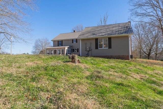 rear view of property with a sunroom