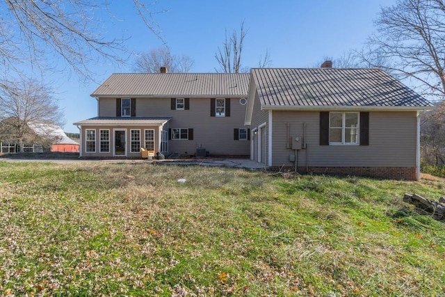 back of property with a lawn, a patio, and central air condition unit