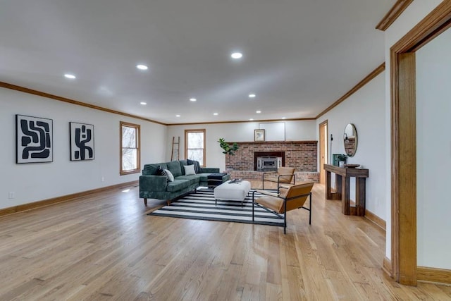 living room featuring ornamental molding, a fireplace, and light hardwood / wood-style flooring