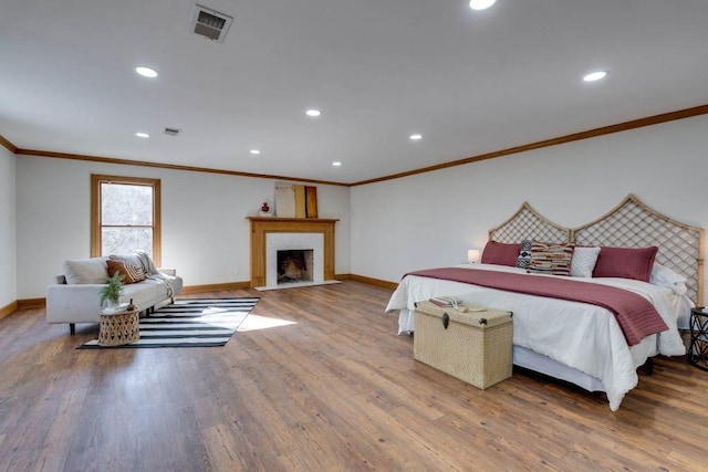 bedroom with crown molding and wood-type flooring