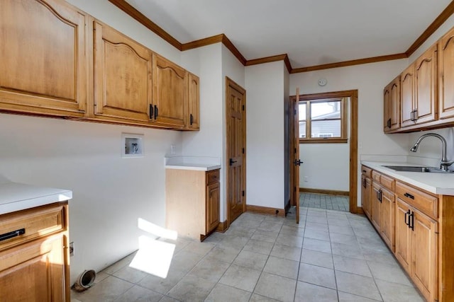 laundry area with sink, crown molding, cabinets, light tile patterned floors, and washer hookup