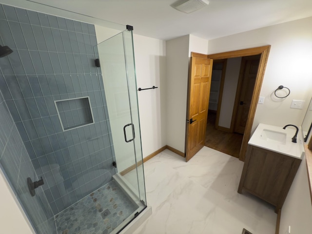 bathroom with vanity and a shower with shower door