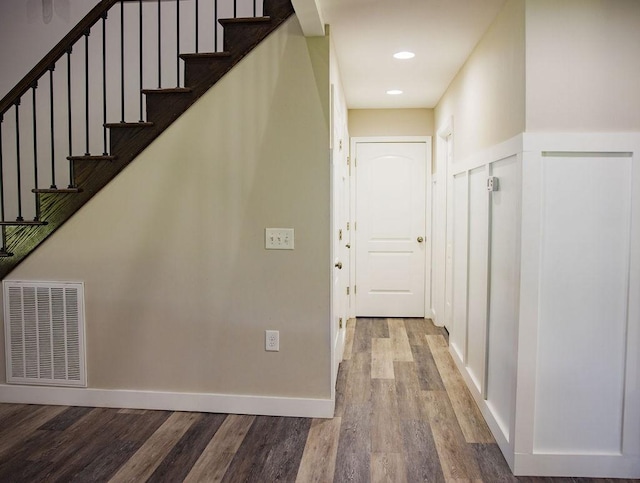 staircase with wood-type flooring