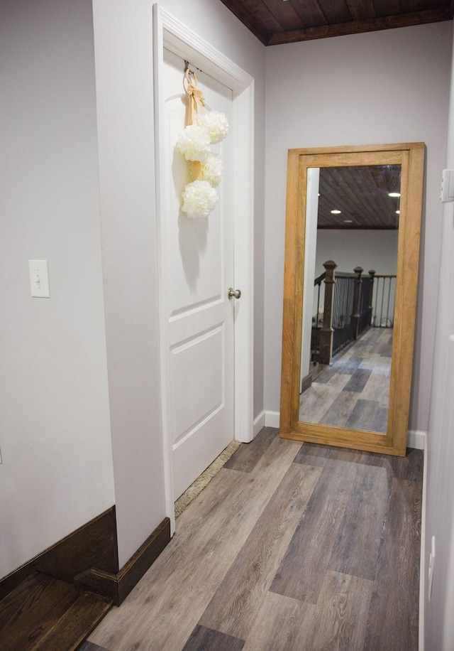 hall featuring wood ceiling and hardwood / wood-style flooring