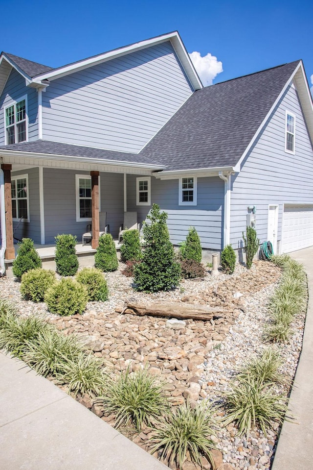 view of front of property featuring a garage and covered porch