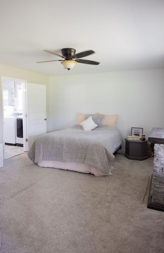 carpeted bedroom featuring ceiling fan and washer / dryer