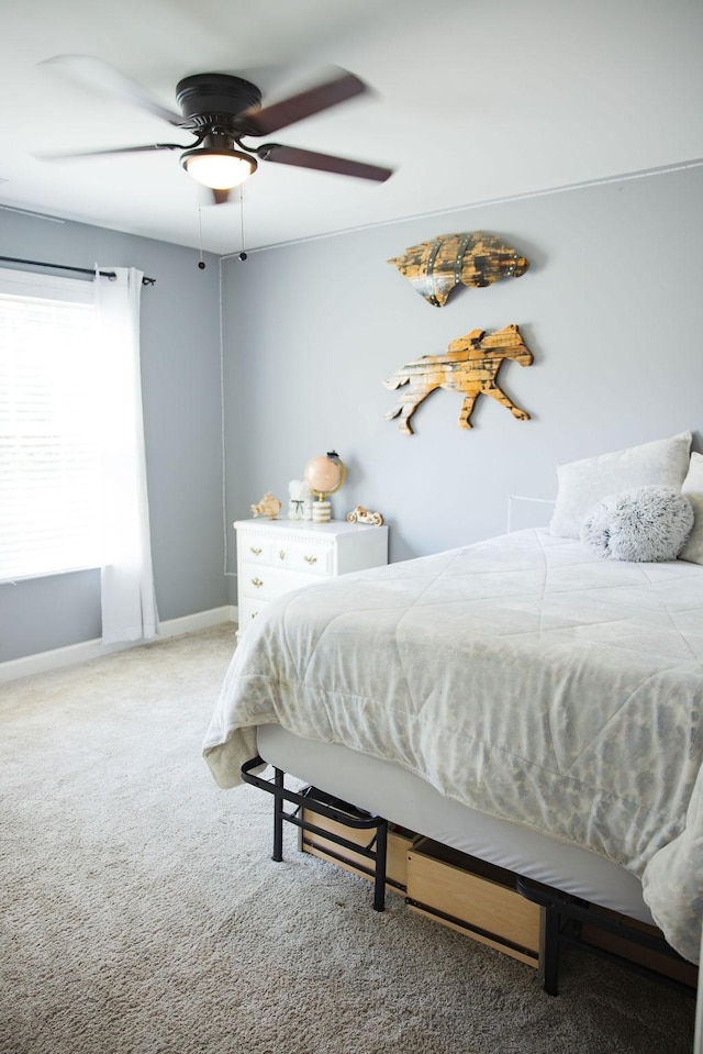 bedroom featuring ceiling fan and carpet