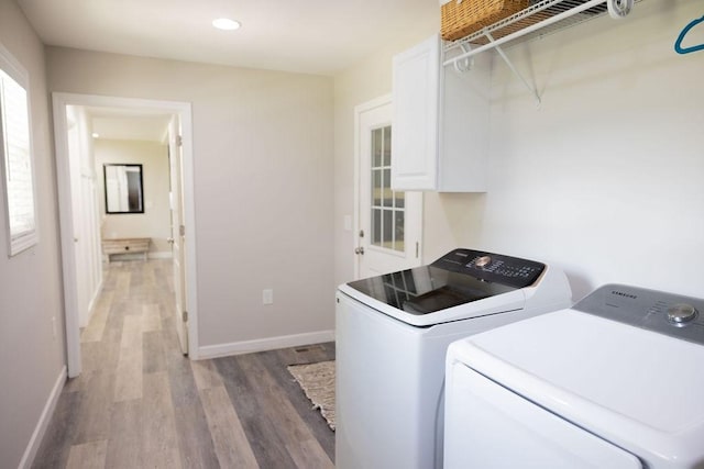 washroom featuring independent washer and dryer and wood-type flooring