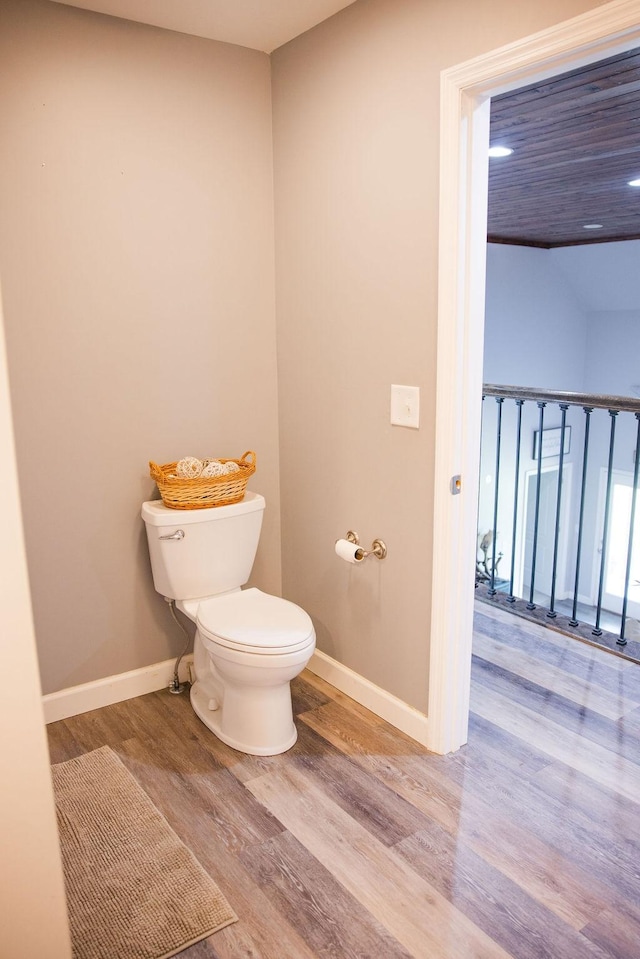 bathroom with hardwood / wood-style floors and toilet