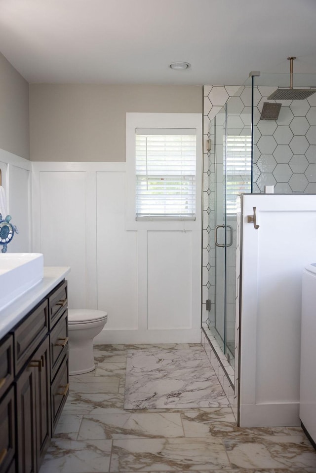 bathroom with vanity, an enclosed shower, and toilet