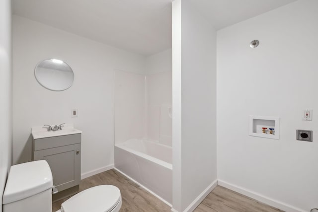 full bathroom with wood-type flooring, vanity, shower / bathtub combination, and toilet