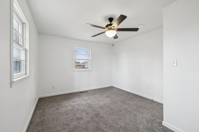 carpeted spare room with ceiling fan