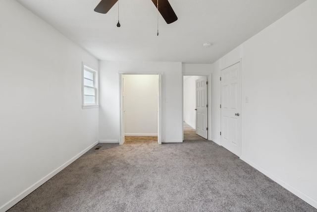 unfurnished bedroom with ceiling fan and carpet