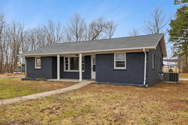 single story home featuring cooling unit and a front lawn