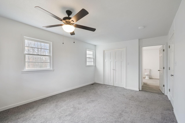 unfurnished bedroom with carpet, ceiling fan, and a closet