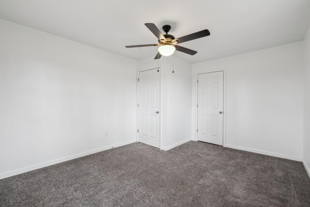 carpeted spare room with ceiling fan