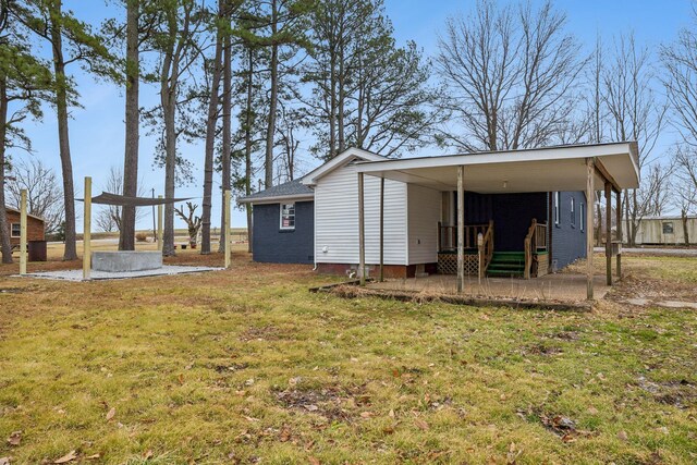 view of outdoor structure featuring a lawn and a carport