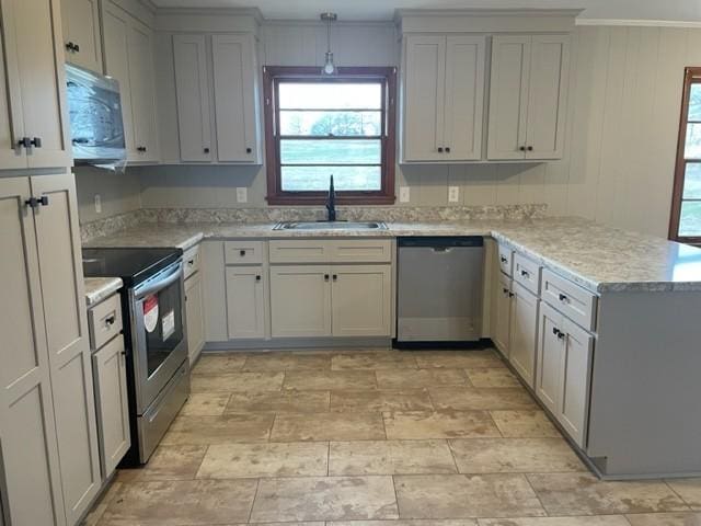 kitchen featuring appliances with stainless steel finishes, sink, gray cabinetry, and kitchen peninsula