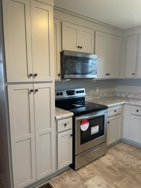 kitchen with light stone counters and stainless steel appliances