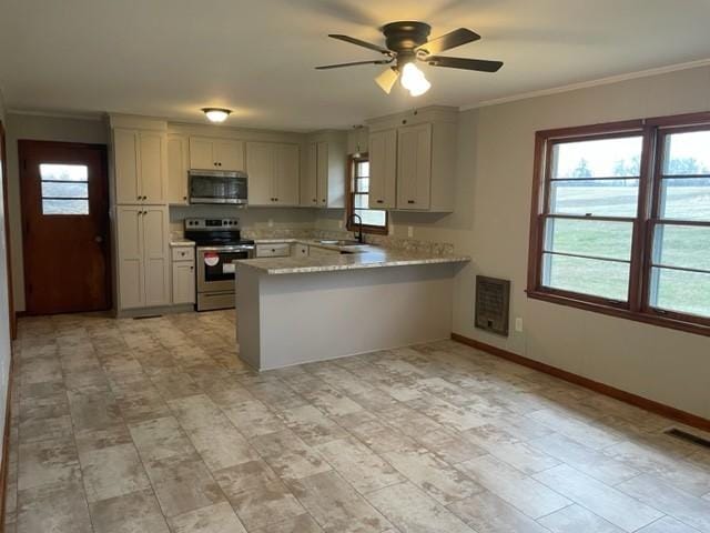 kitchen with sink, ceiling fan, stainless steel appliances, ornamental molding, and kitchen peninsula