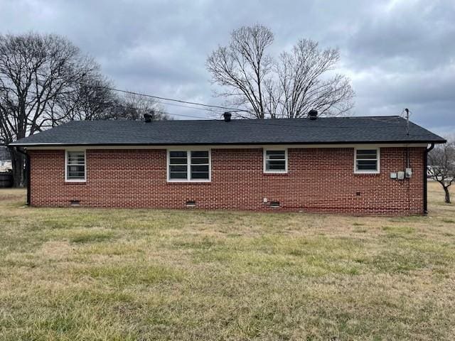 rear view of property featuring a yard