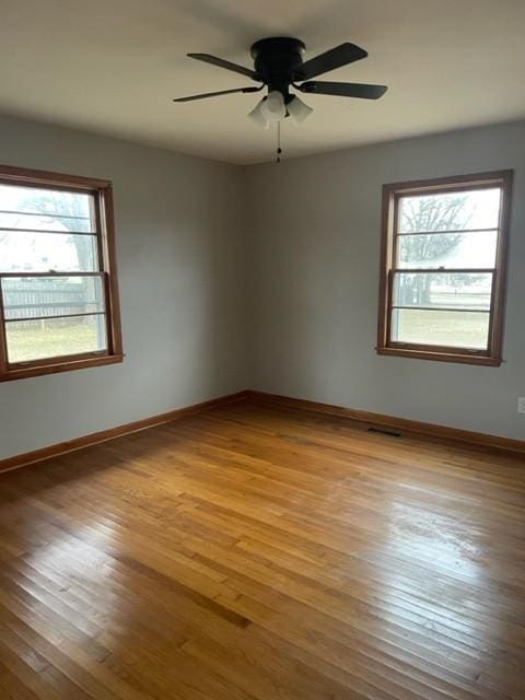 spare room with ceiling fan and light hardwood / wood-style floors