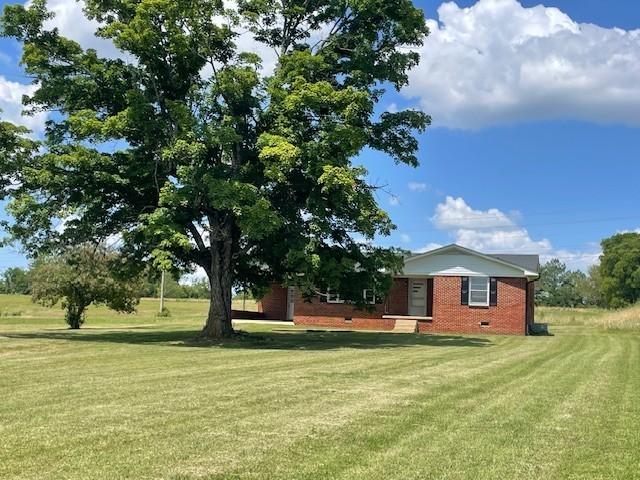 view of home's exterior with a lawn