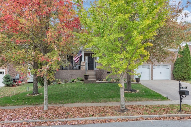 view of property hidden behind natural elements featuring a garage and a front yard