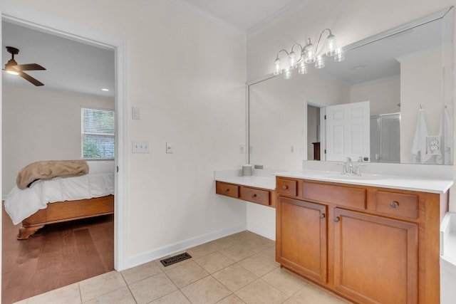 bathroom with crown molding, ceiling fan, tile patterned floors, and vanity