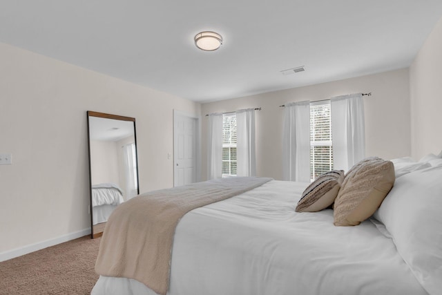 bedroom with light colored carpet