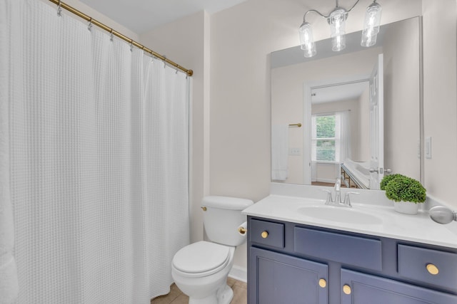 bathroom with vanity, tile patterned floors, and toilet