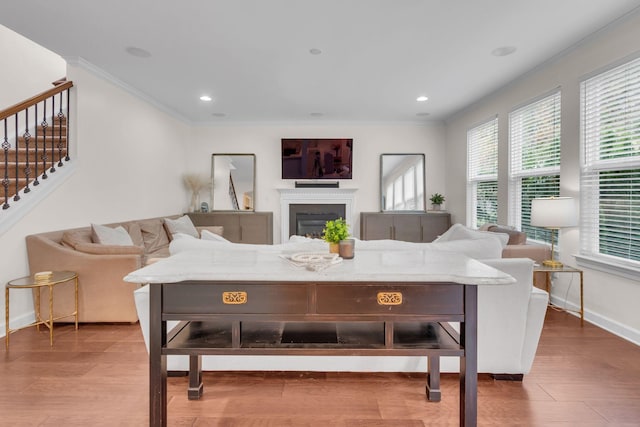 living room with hardwood / wood-style flooring and ornamental molding