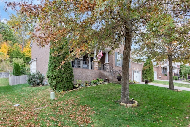 view of property hidden behind natural elements with a front yard