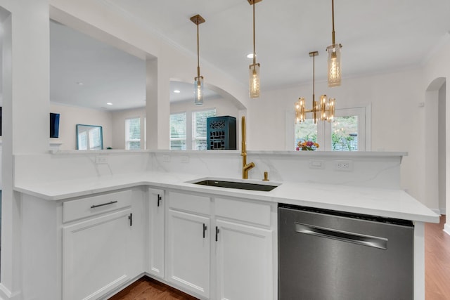 kitchen with sink, dishwasher, white cabinetry, hanging light fixtures, and light stone counters