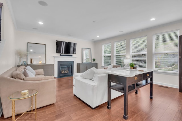 living room featuring hardwood / wood-style flooring and ornamental molding