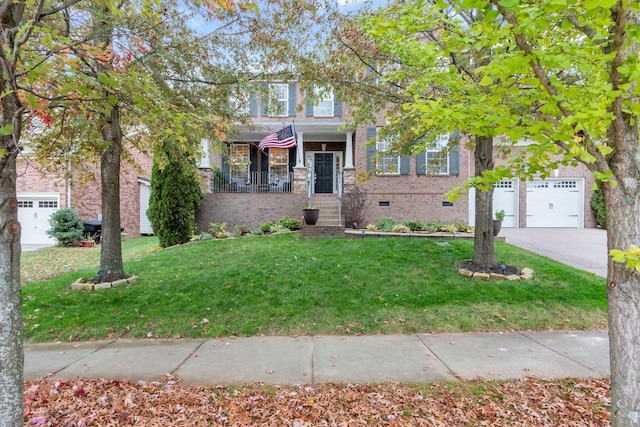 view of front facade with a garage, a front yard, and covered porch