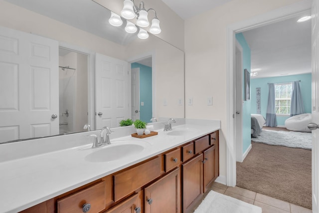 bathroom featuring vanity, tile patterned floors, and a chandelier